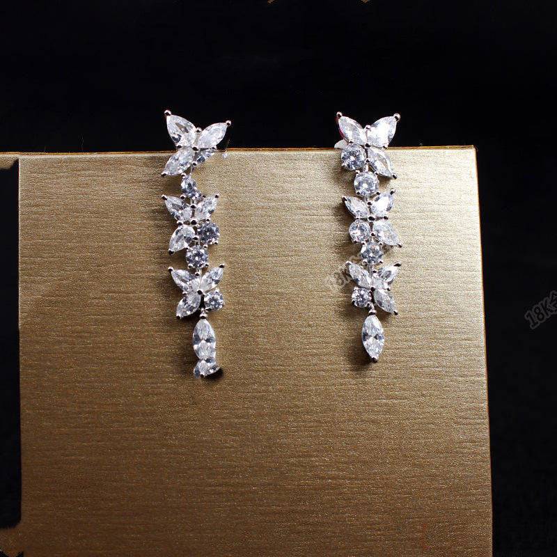 18k white gold moissanite diamond earrings with a row of diamonds