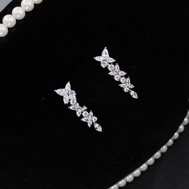 18k white gold moissanite diamond earrings with a row of diamonds