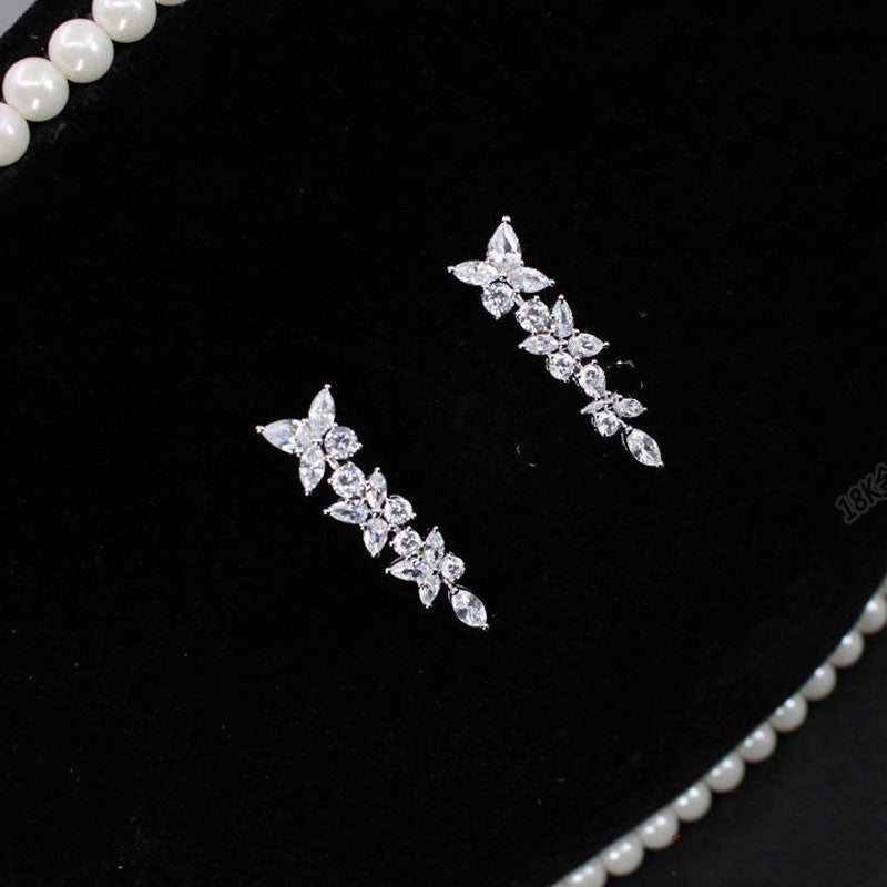 18k white gold moissanite diamond earrings with a row of diamonds