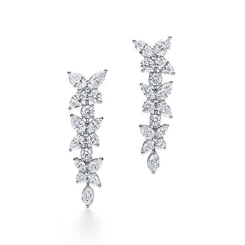 18k white gold moissanite diamond earrings with a row of diamonds